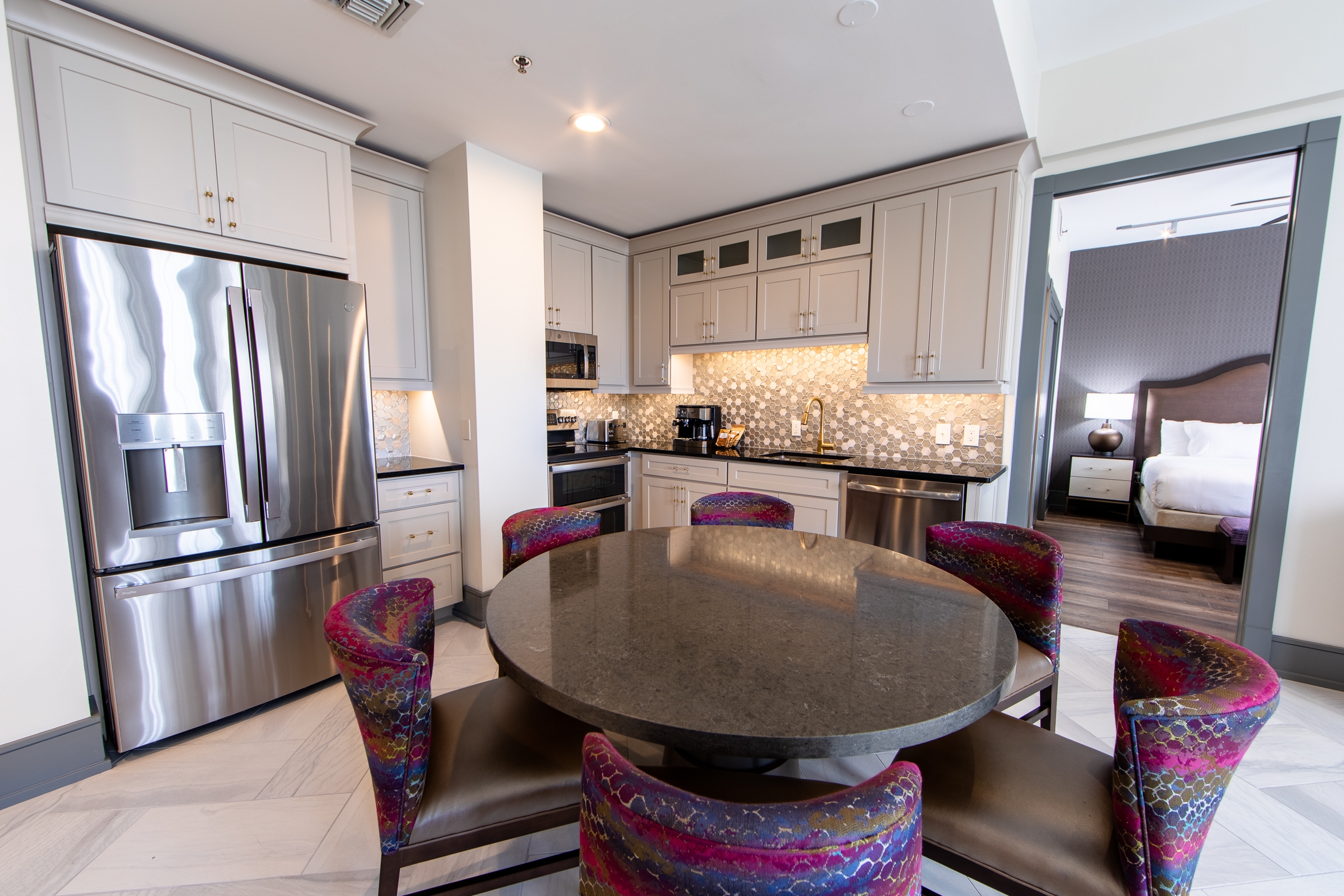 Signature Collection two-bedroom villa dining area table, five chairs and full kitchen at New Orleans Resort in Louisiana.