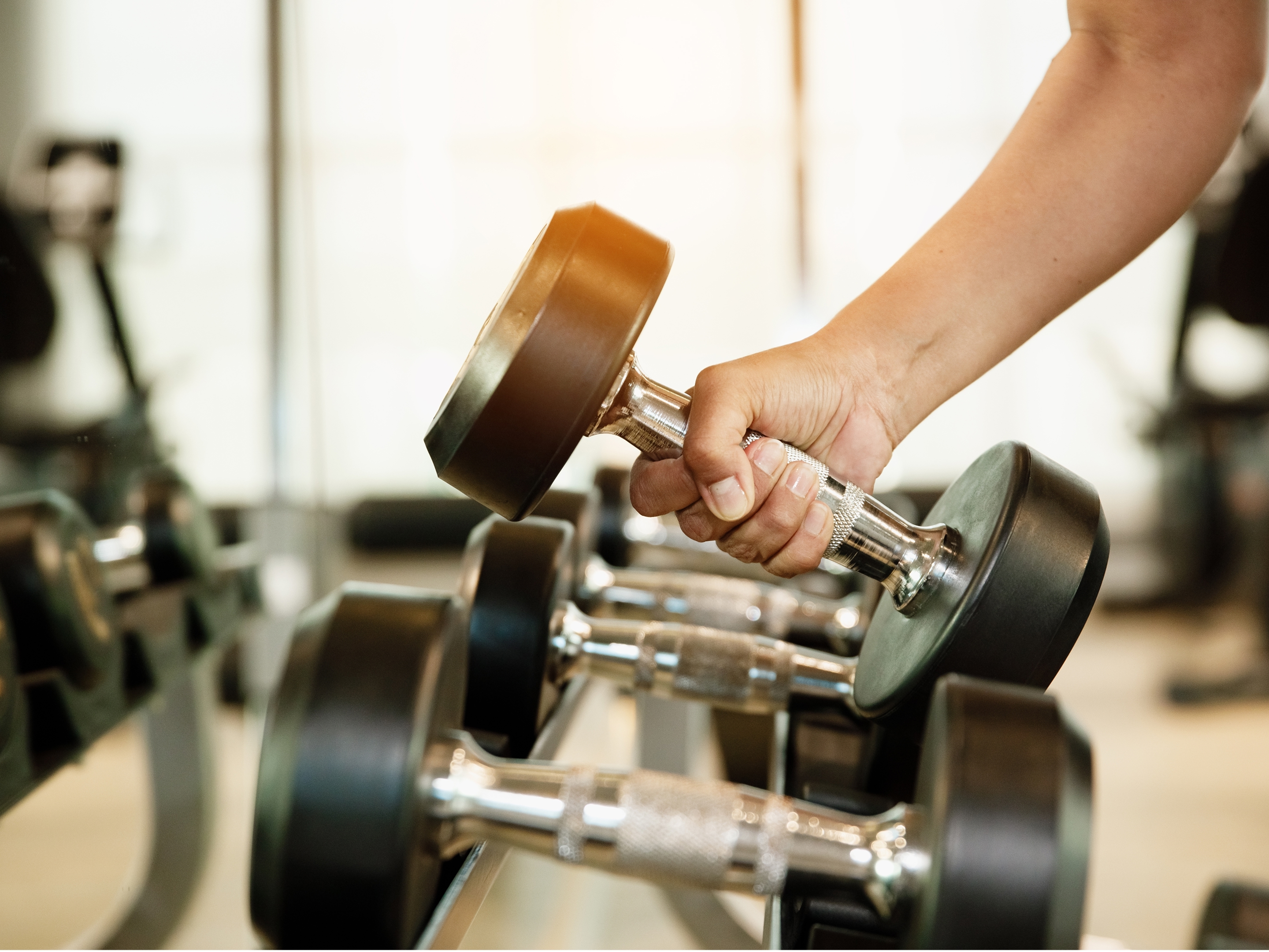  Guest lifting a dumbbell in the 24-hour fitness center at Holiday Inn Club Vacations at Banneker. 