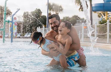 Family in pool at Cape Canaveral Beach Resort in Florida.