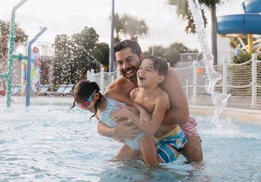Family in pool at Cape Canaveral Beach Resort in Florida.
