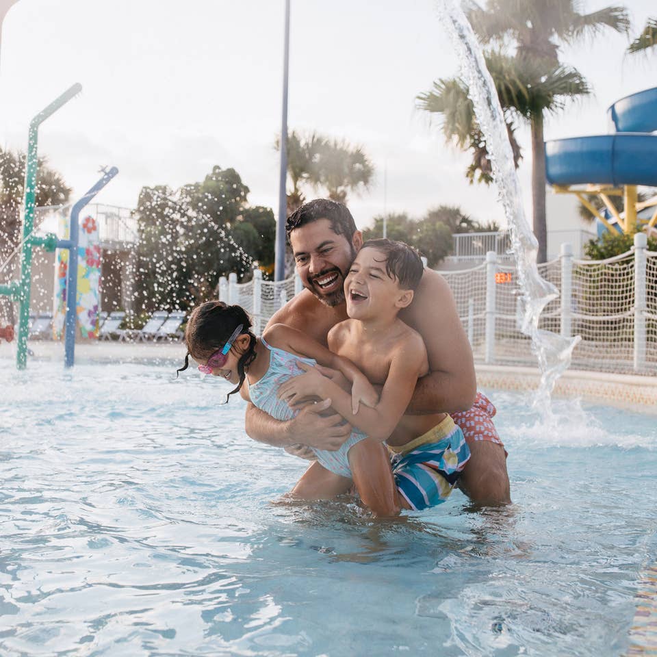 Family in pool at Cape Canaveral Beach Resort in Florida.