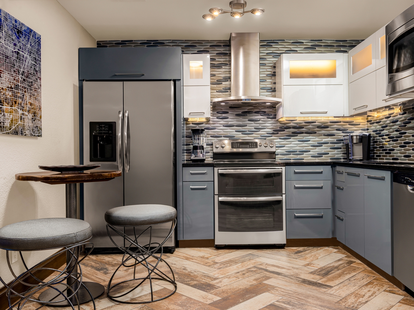Stylish kitchen with modern appliances and mosaic backsplash.
