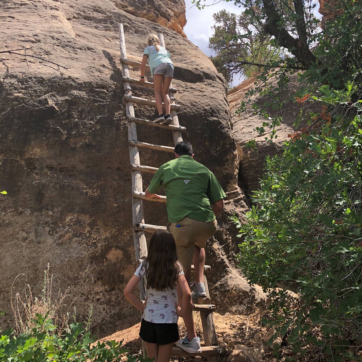 Chris' husband and daughters climb the ladder at Canyonlands National Park.