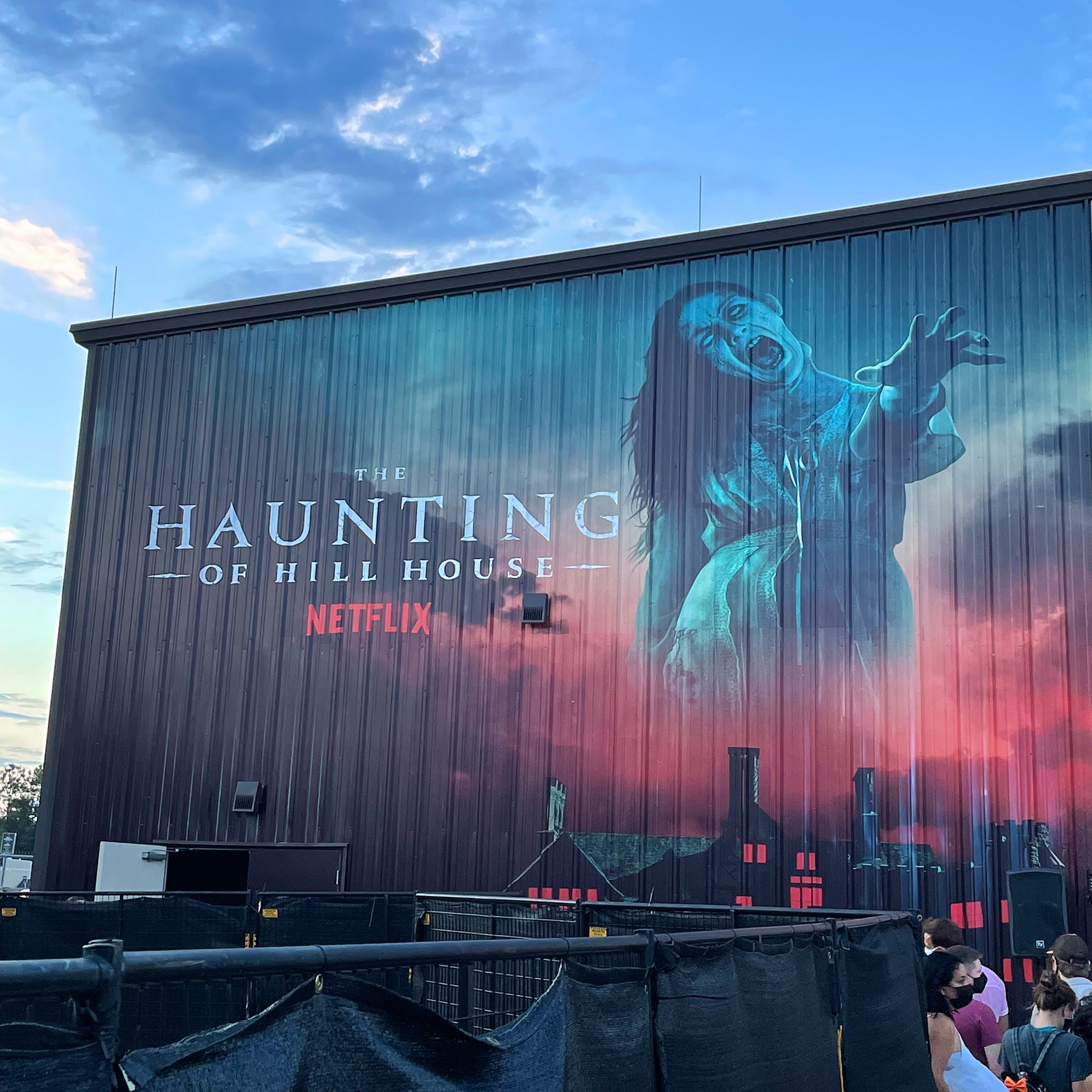 Building exterior with spooky mural.