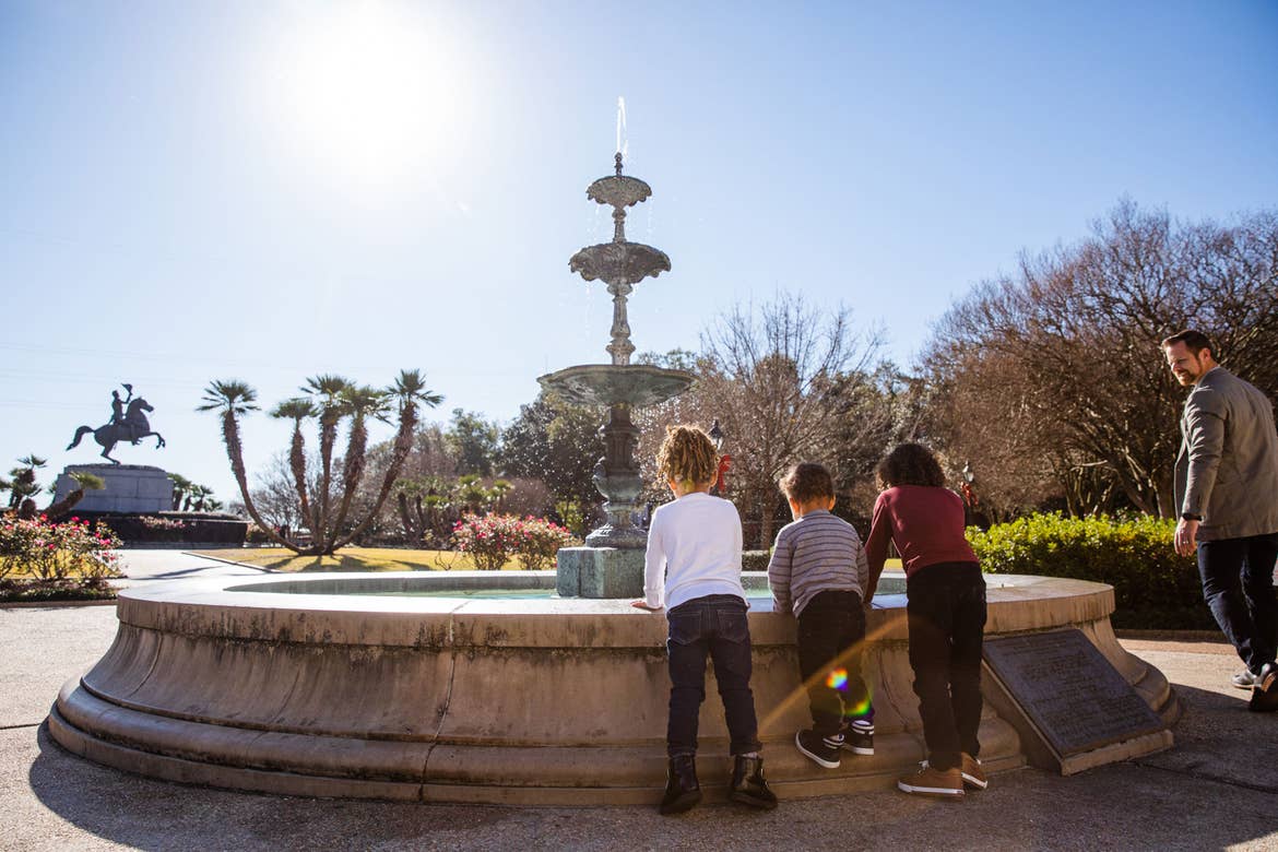 Featured Contributor, Sally Butan of @butanclan's children,  Alissa (left), Alston (middle) and Alex (right) stand near the fountain at Jackson Square of New Orleans, Louisiana.