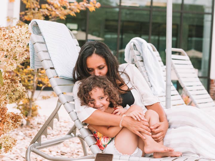 Mother and daughter sitting in a pool chair at Williamsburg Resort in Virginia.