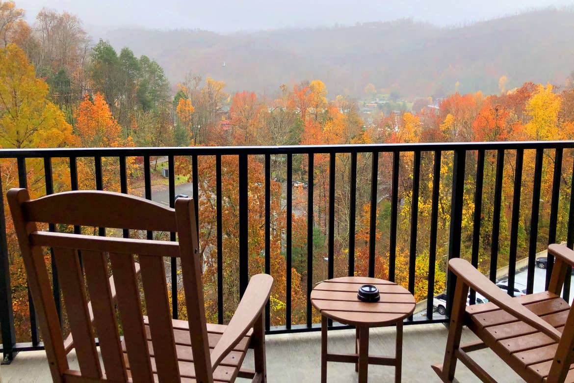 Two rocking chairs face towards fall foliage on the patio of our villa at Smoky Mountain Resort in Gatlinburg, Tennessee.