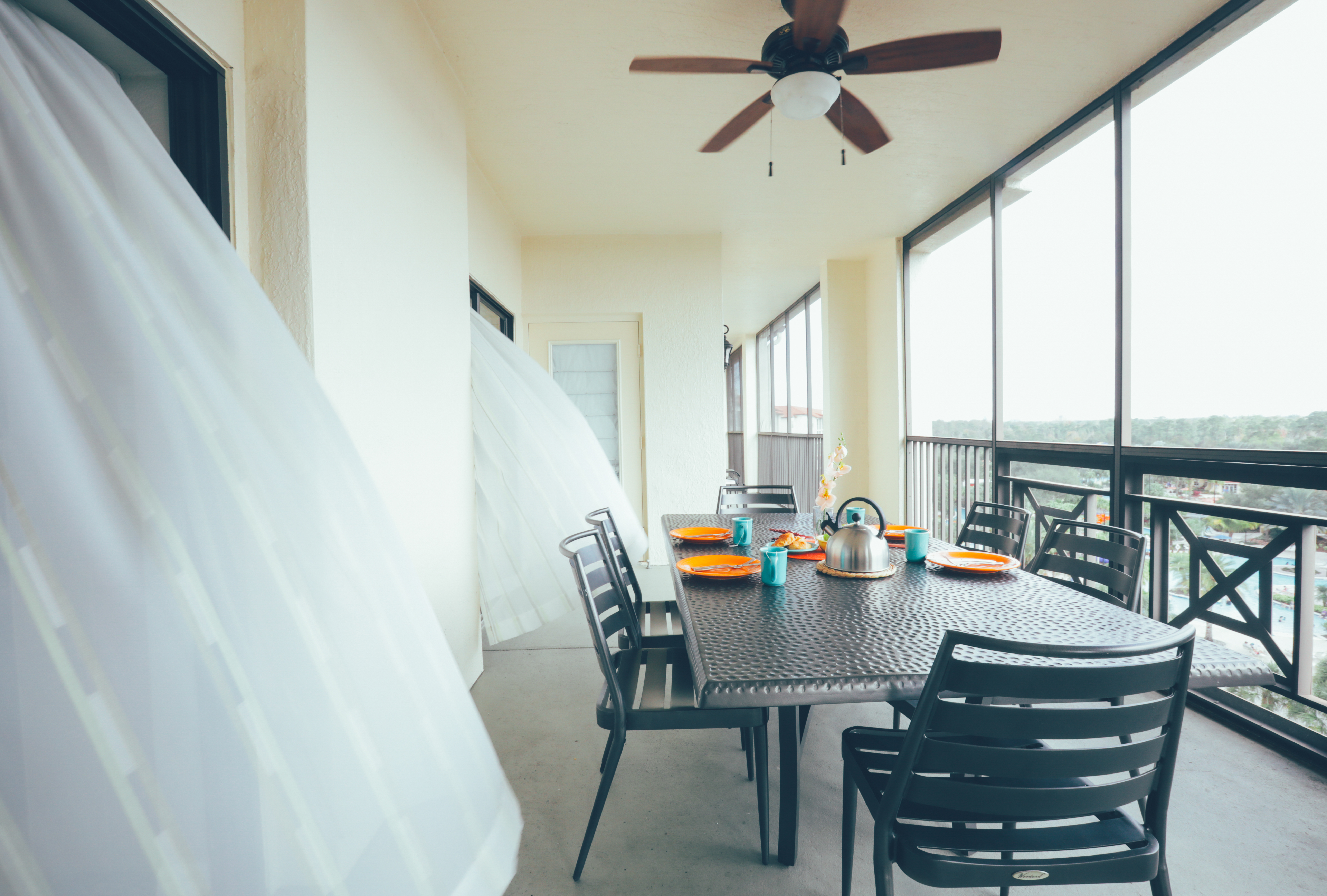 Furnished balcony with table and six chairs in a villa in River Island at Orange Lake Resort near Orlando, Florida