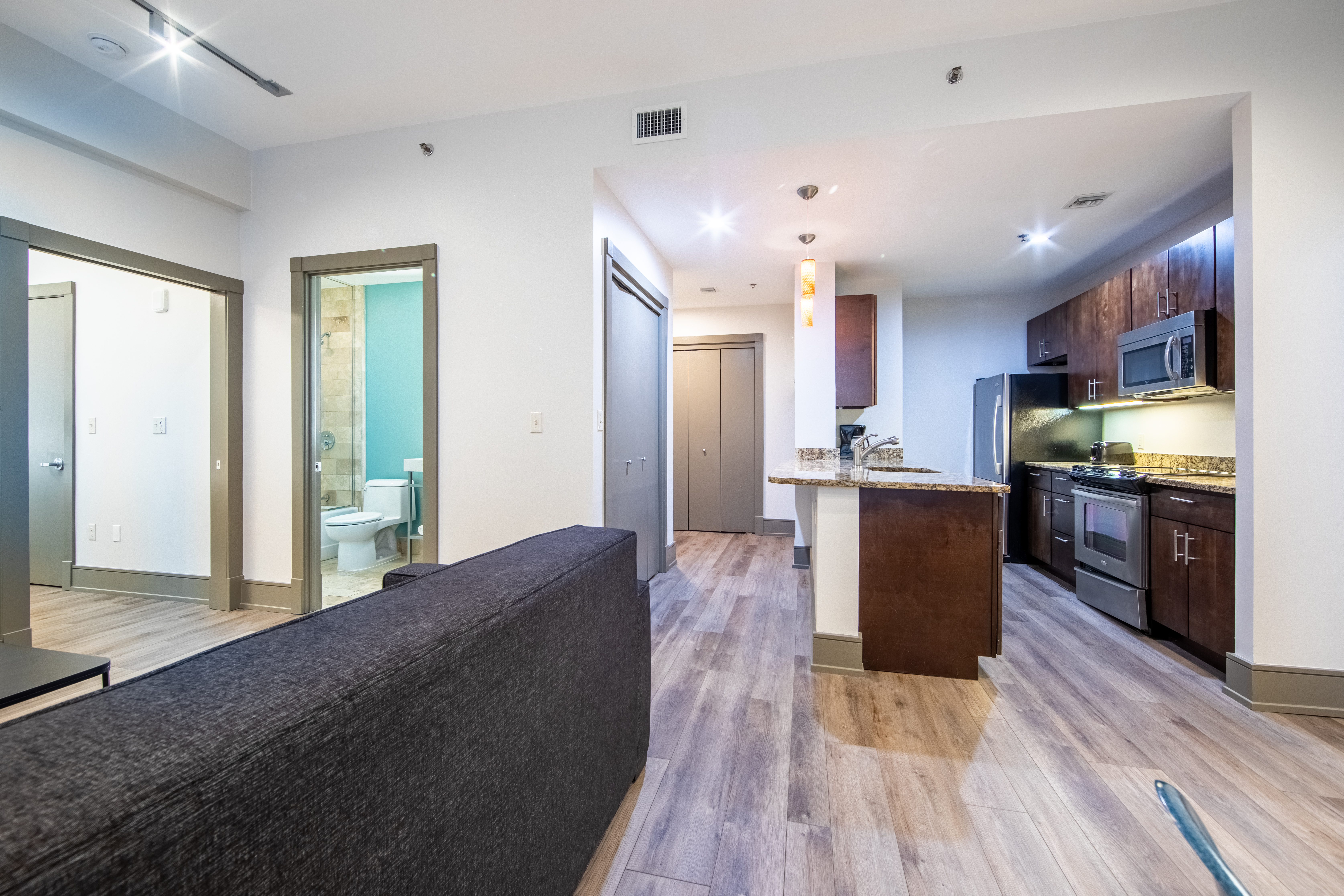 Two bedroom villa with view of full kitchen, bathroom and couch at New Orleans Resort in Louisiana.