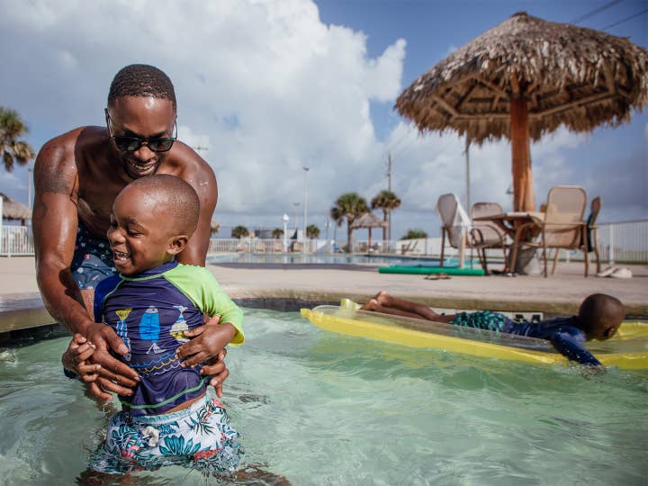 Dad with son at the pool in Galveston, Texas