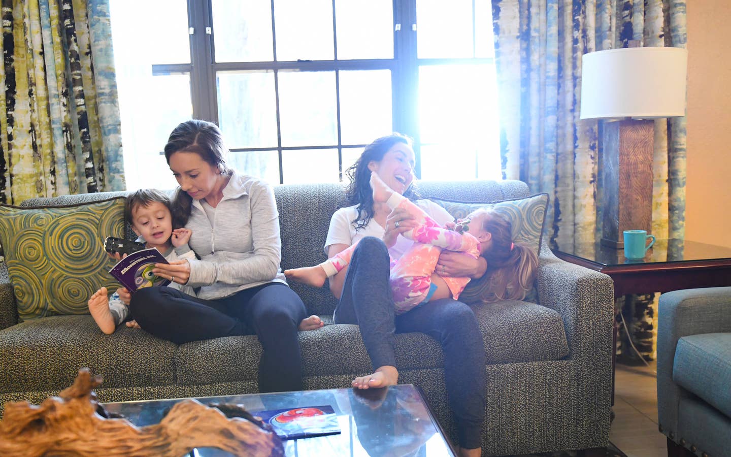Family reading and laughing on a sofa