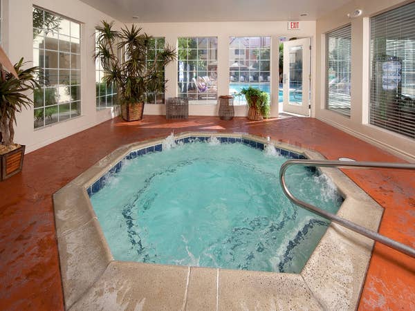 Indoor hot tub with view of outdoor pool at Desert Club Resort in Las Vegas, Nevada