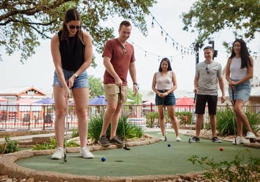 Friends playing mini golf at Hill Country Resort in Canyon Lake, Texas.