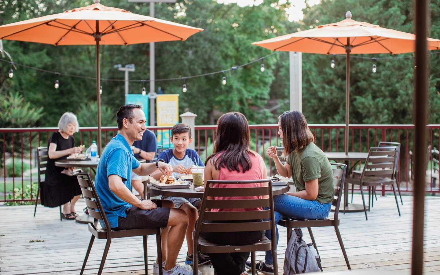 Family of four eating on patio of Grill at Villages Resort in Flint, Texas.
