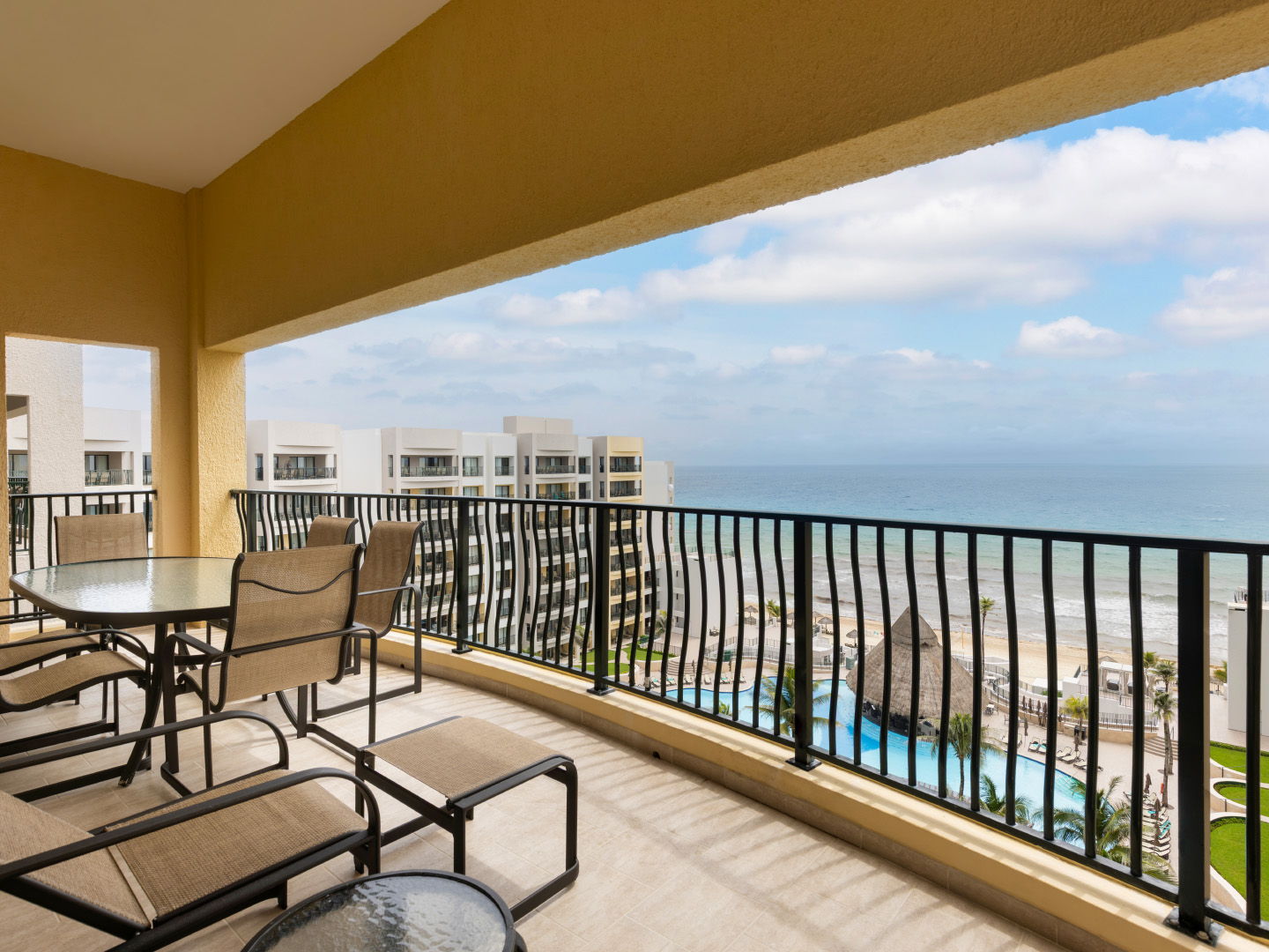 Spacious oceanview balcony with loungers and dining set. 