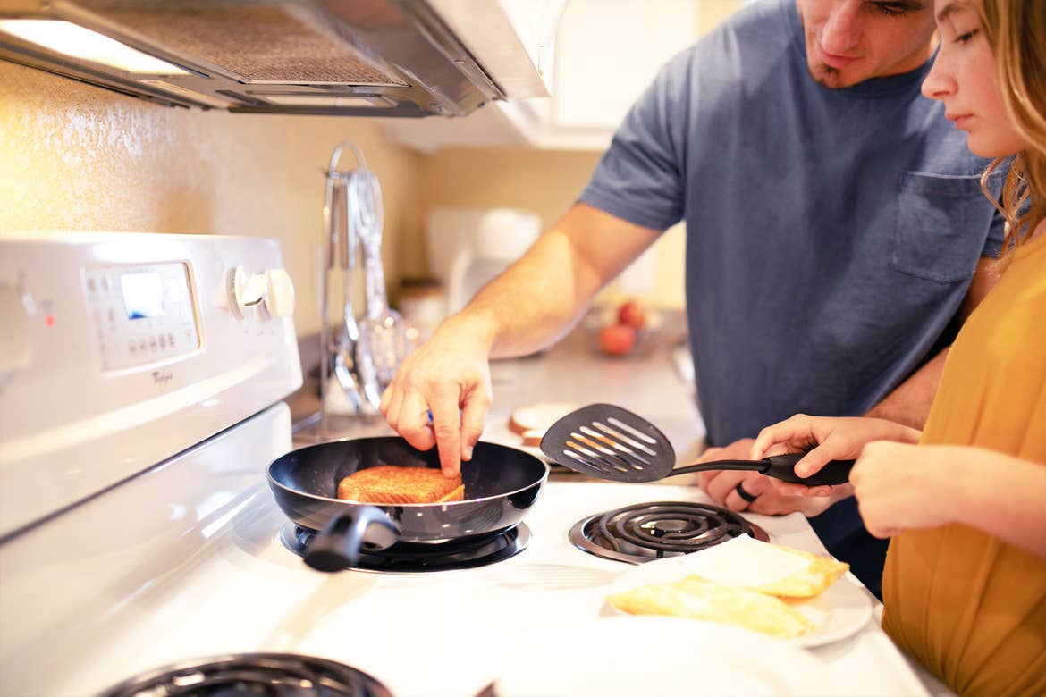 Ashley Haby's husband (left) and daughter (right) making grilled cheese Sammies on the stovetop at our Villages Resort.