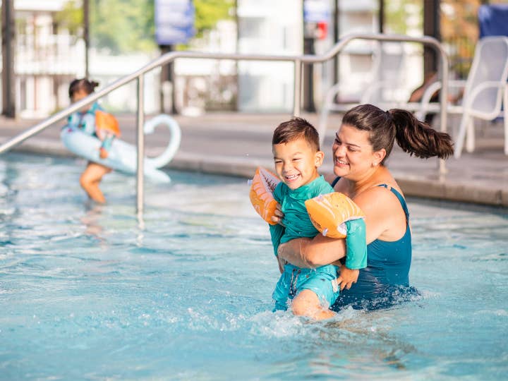 Adult and child playing in pool at Holiday Hills Resort in Branson, Missouri.