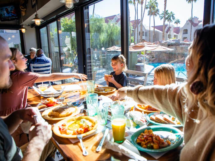 Family eating breakfast at Gold Mine Bar & Grill at Desert Club Resort in Las Vegas, Nevada