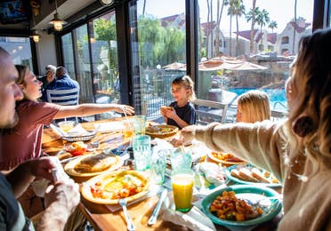 Family eating breakfast at Gold Mine Bar & Grill at Desert Club Resort in Las Vegas, Nevada