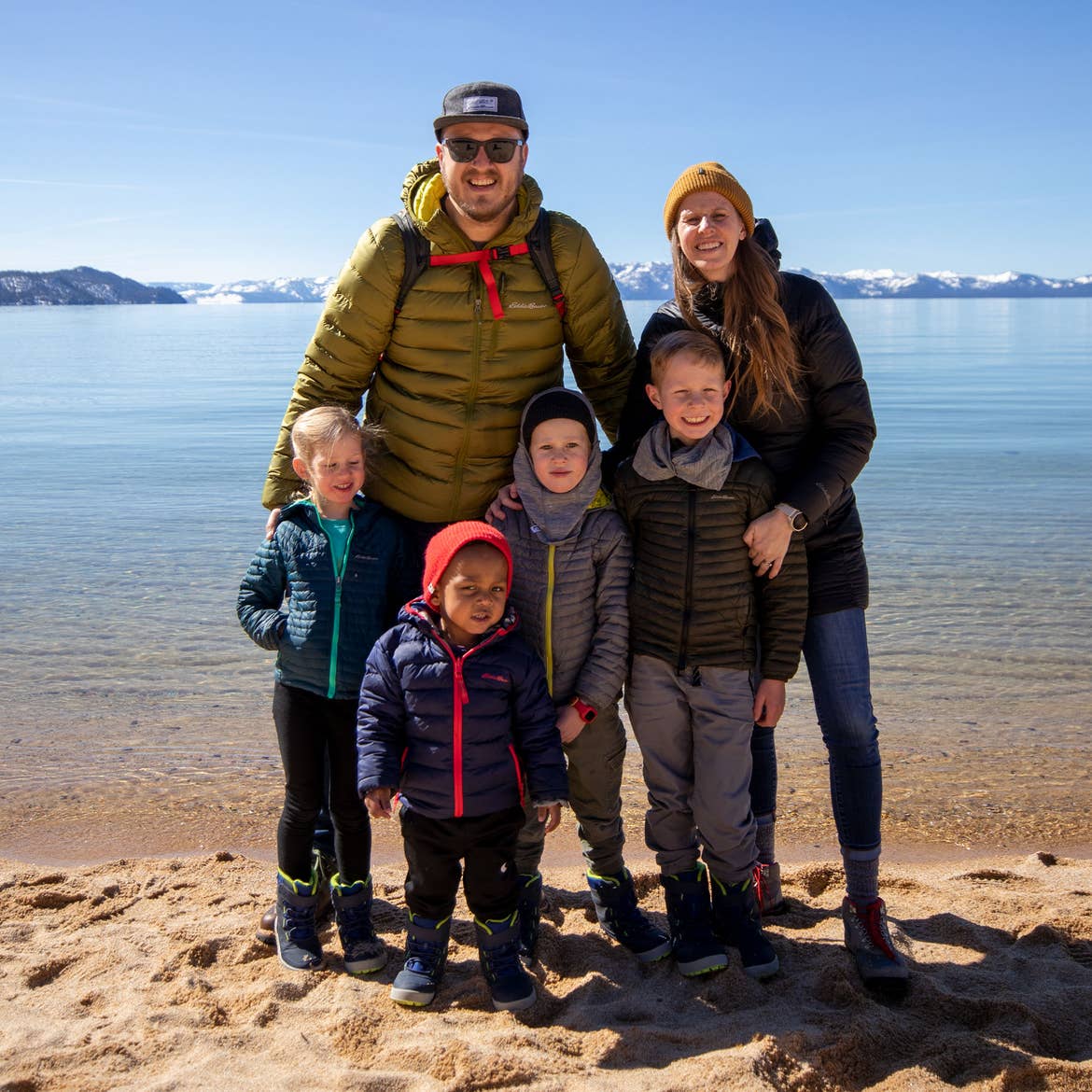 Featured Contributor, Andrea Rassmussen (back-right), stands with her family on the sands at Sand Harbor in Nevada State Park.