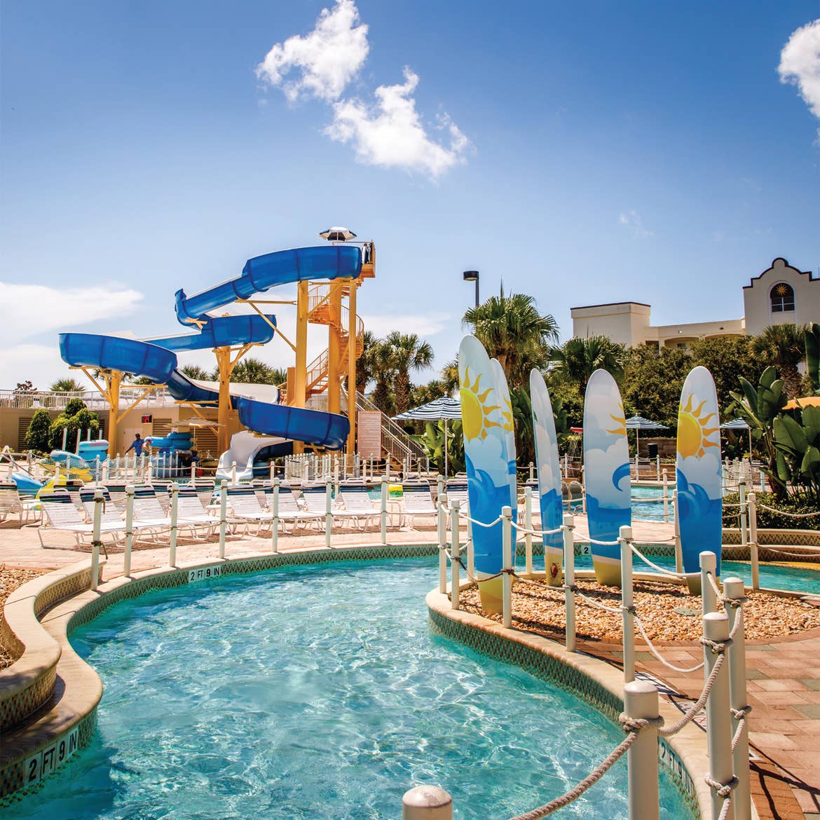 Lazy river with waterslide in the background at Cape Canaveral Beach Resort.