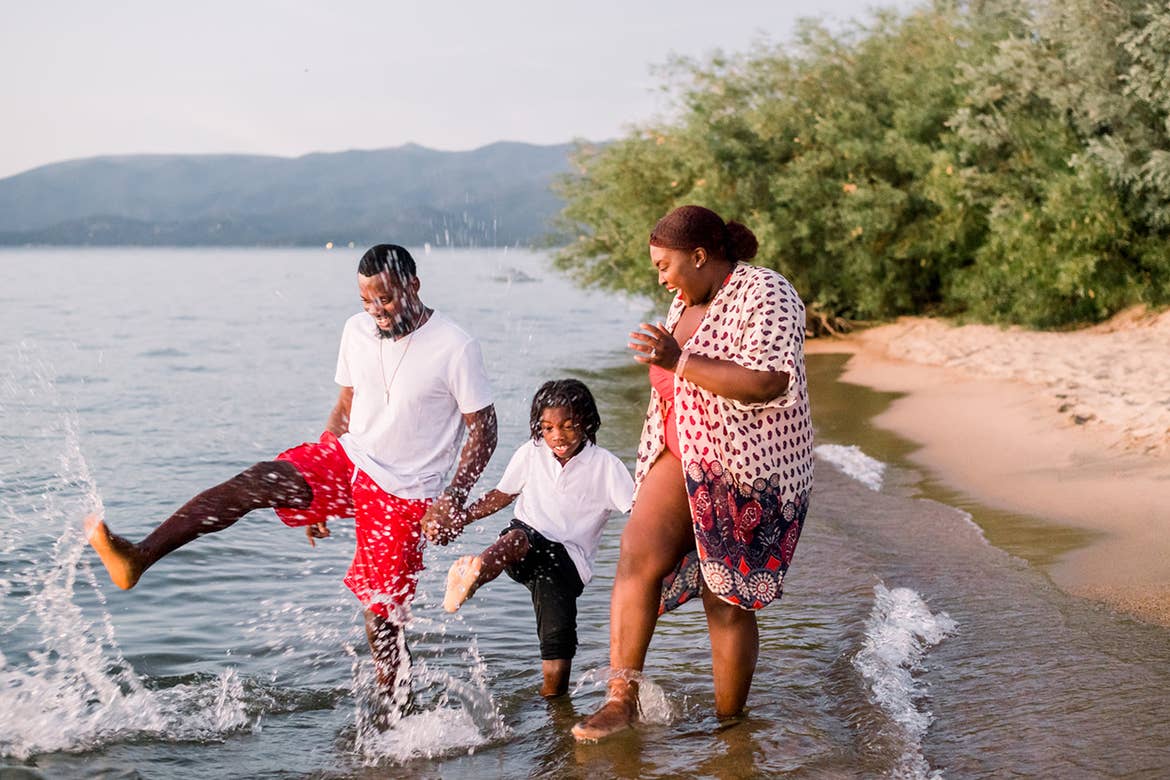 Karen and her family splashing in the water at Tahoe Keys Beach