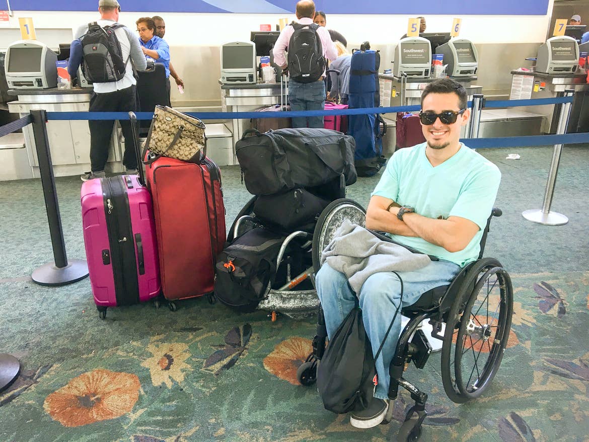 Danny at the airport next to all his luggage