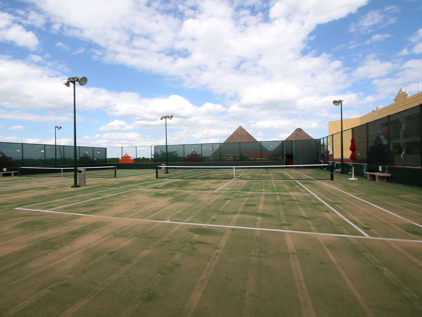 Angled view of the lawn tennis courts, at The Royal Haciendas, in Playa del Carmen, Mexico