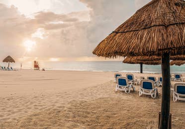 Umbrellas and sun chairs on a beach in Mexico.