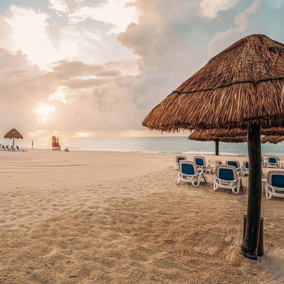 Umbrellas and sun chairs on a beach in Mexico.