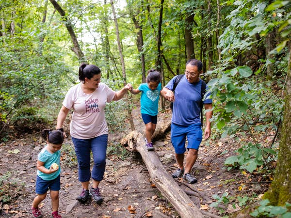 Family of four hiking at Table Rock Lake near Holiday Hills Resort.