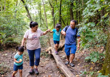 Family of four hiking at Table Rock Lake near Holiday Hills Resort.