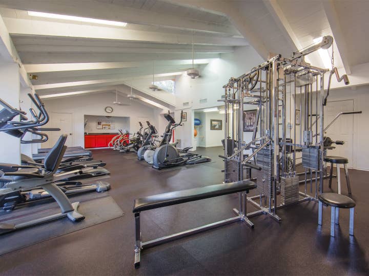 Fitness center with treadmills, weight benches and ellipticals at Holly Lake Resort in Texas.