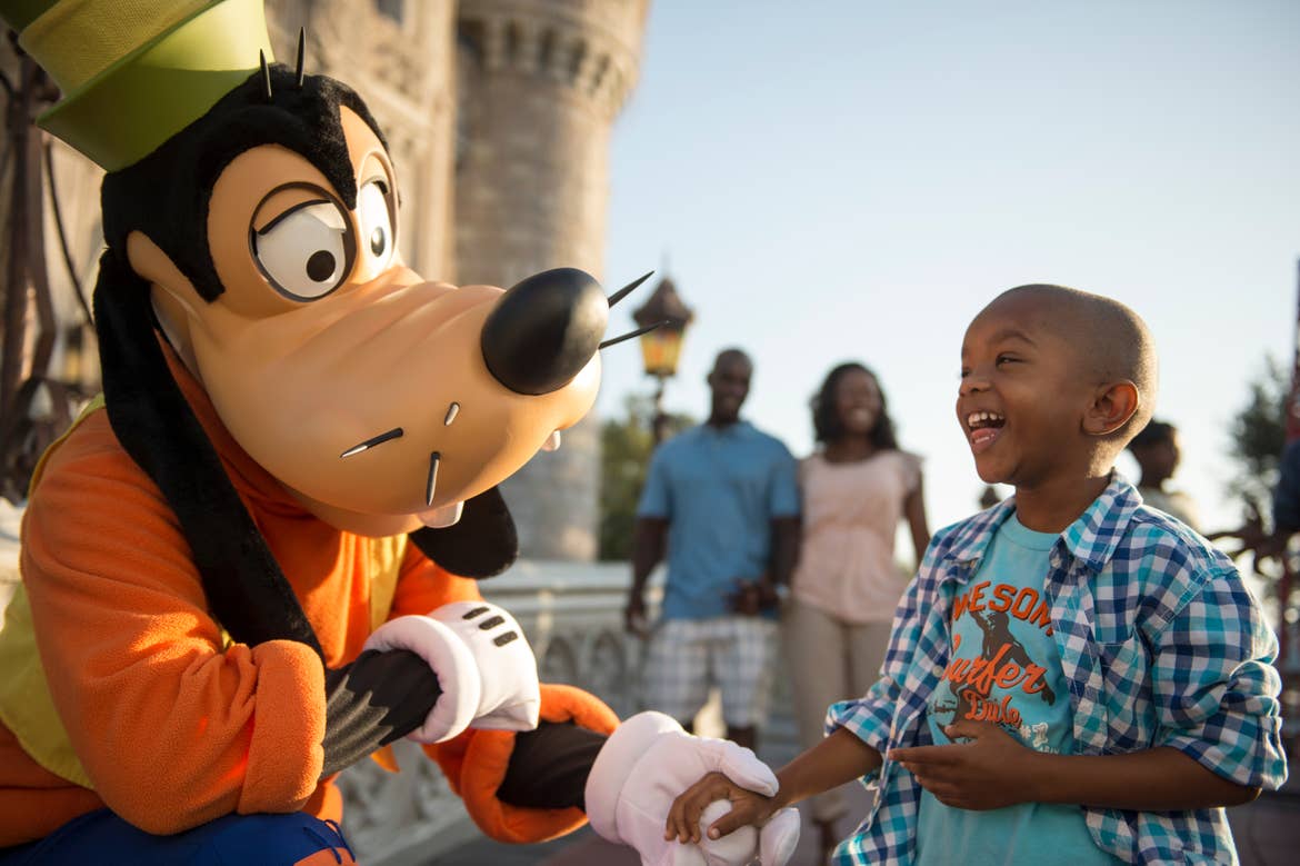 Child shaking hands with Goofy at Walt Disney World Theme Parks
