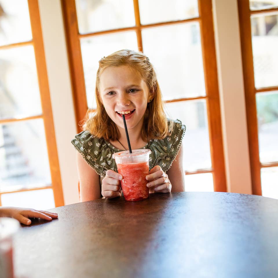Child enjoying an icee beverage at Galveston Seaside Resort.