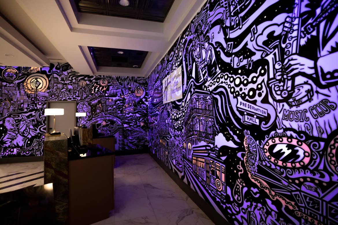 A mural with animated projection mapping in various colors of purple, orange, yellow and magenta featured in the lobby of our resort in New Orleans, Louisiana.