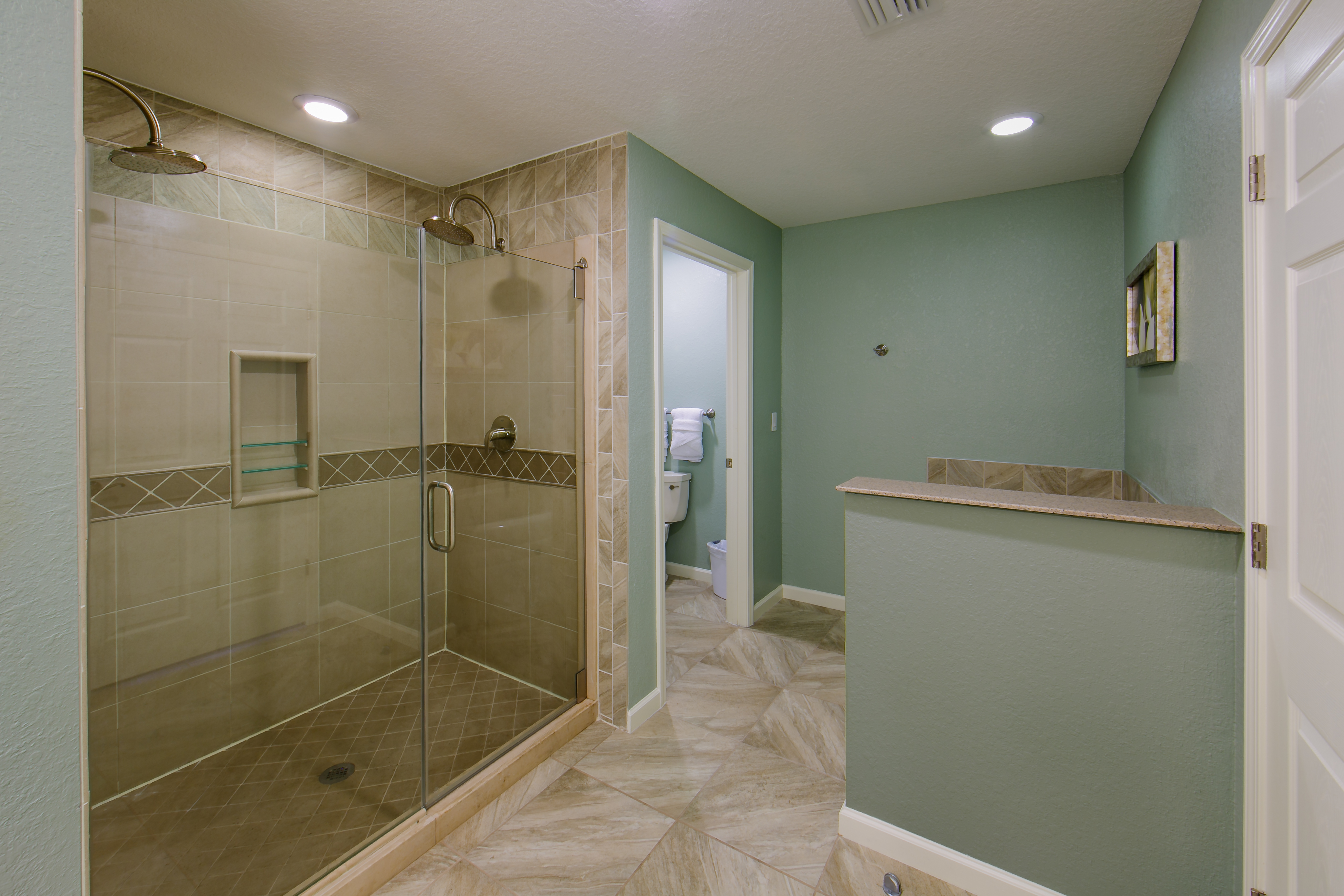 Bathroom with walk-in shower in a villa at Orlando Breeze Resort.