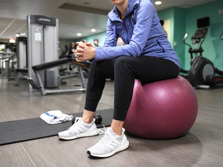 Woman sitting on yoga ball in a fitness center at Lake Geneva Resort in Wisconsin.