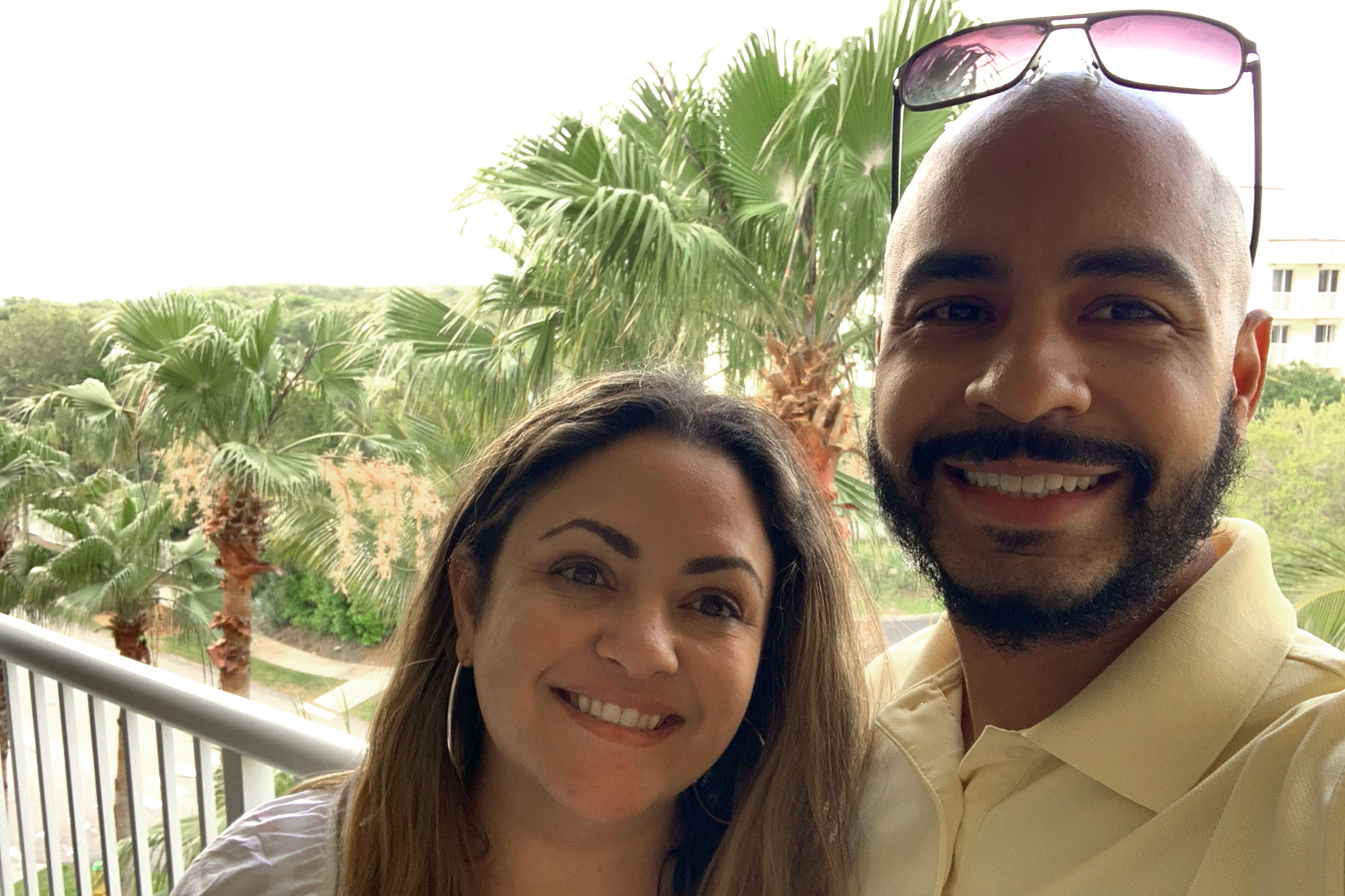 Val (left) and her husband, Gio (right) stand on the balcony of our Cape Canaveral Beach Resort villa.