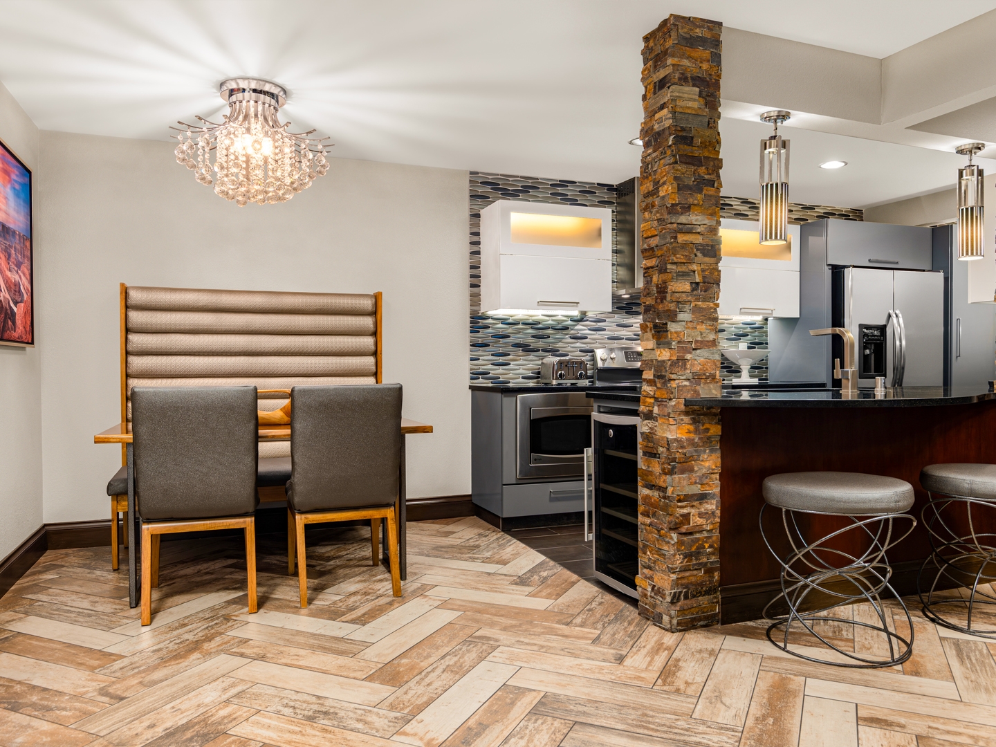 Chic, modern kitchen and dining area with stone accents.
