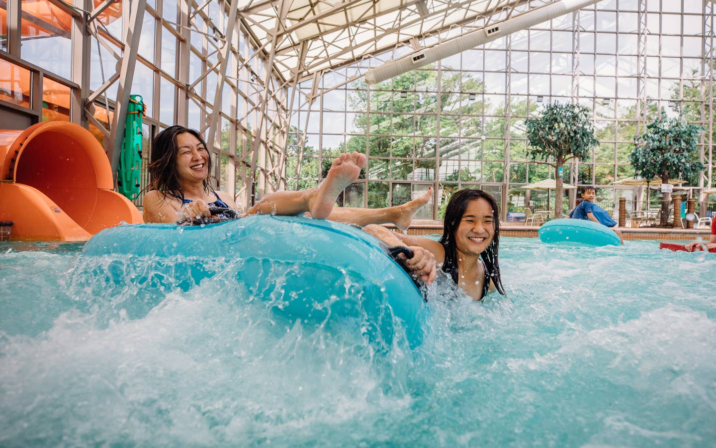 Two guests coming down waterslide in innertube at Waterpark at the Villages at Villages Resort in Flint, Texas.