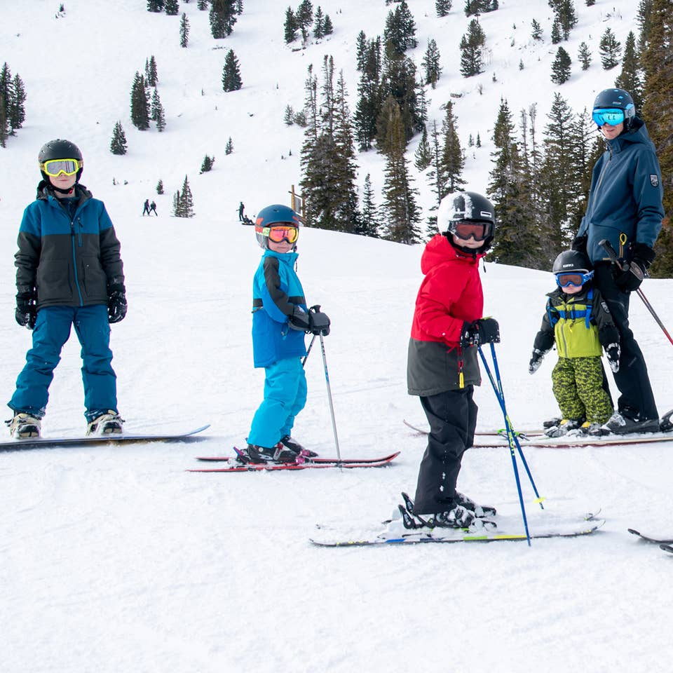 Featured Contributor, Jessica Averett's family, adorn with ski gear, make their way down the snowy slopes.