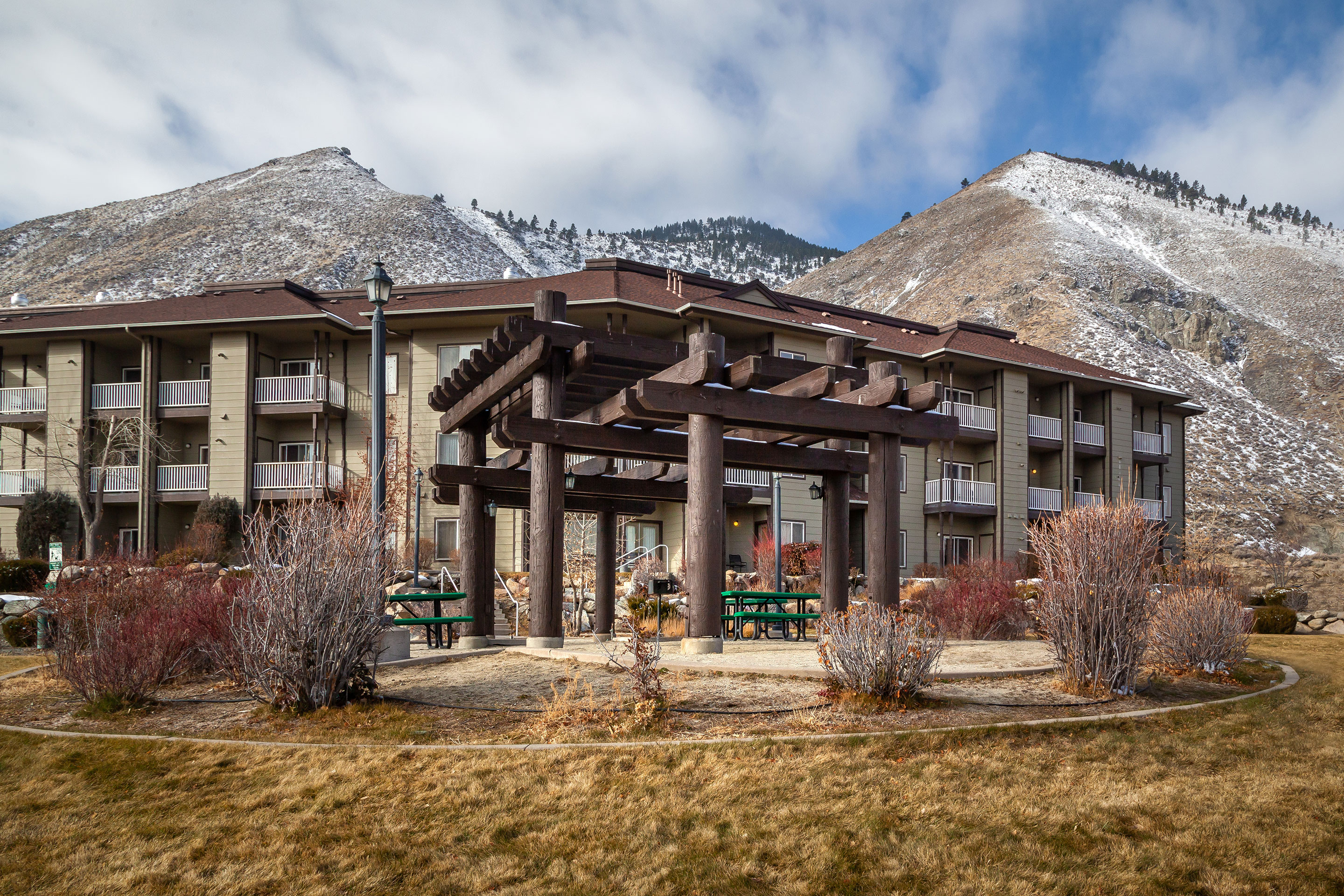 An exterior shot of David Walley’s Resort with snow-capped mountains in the distance.