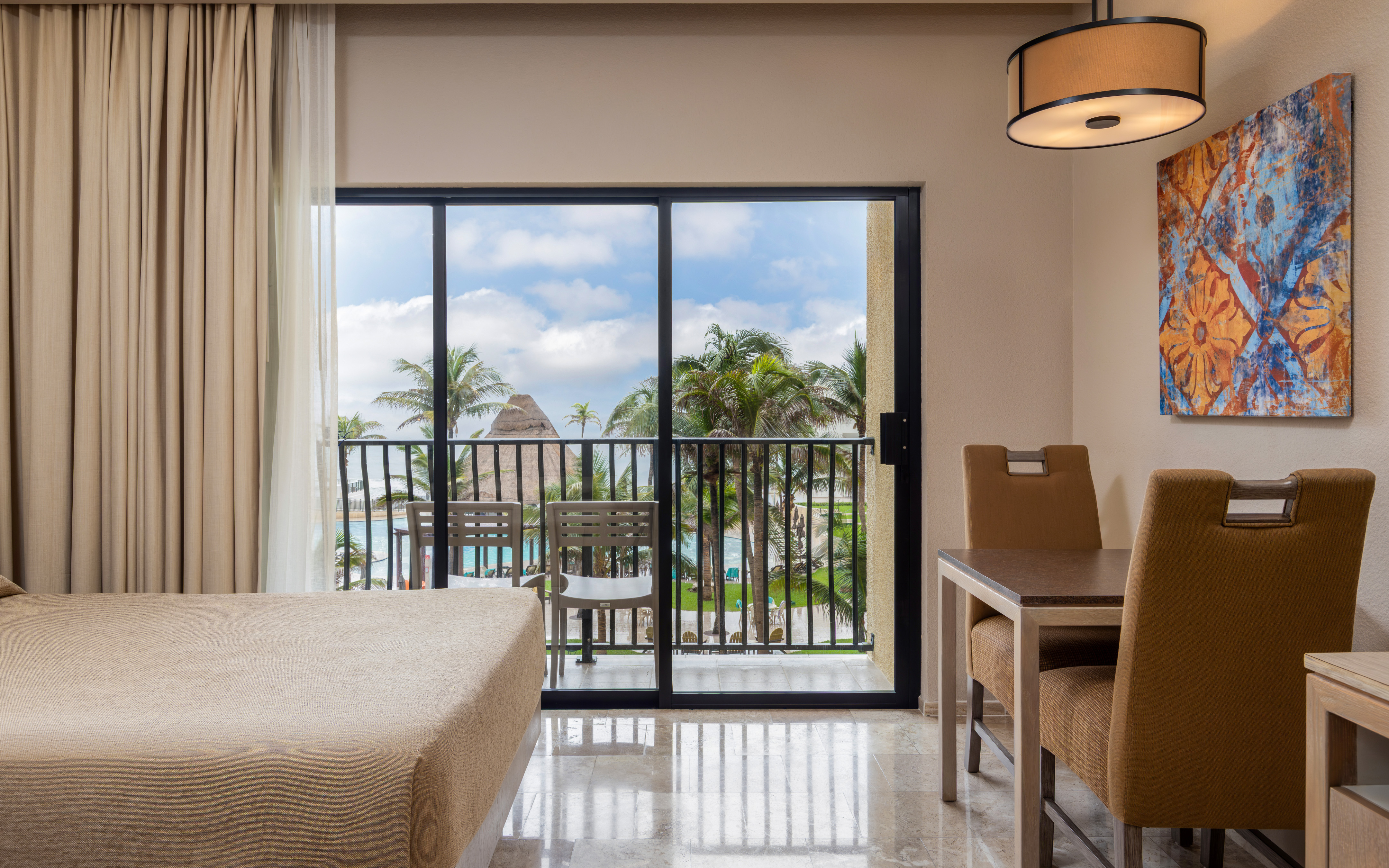 Oceanview room with balcony seating and dining area.