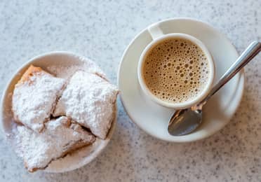 A cup of coffee and three beignets in New Orleans.