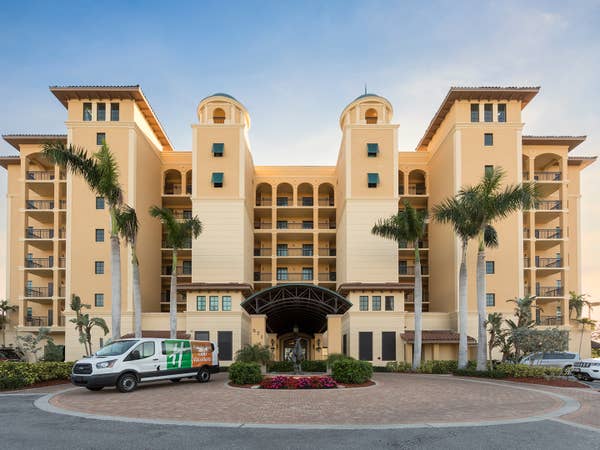 Outdoor view of Sunset Cove Resort with shuttle in the front