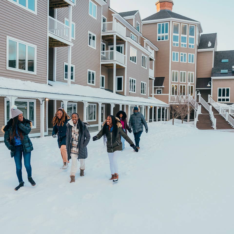 People walking through snow at Mountain Ascutney Resort.