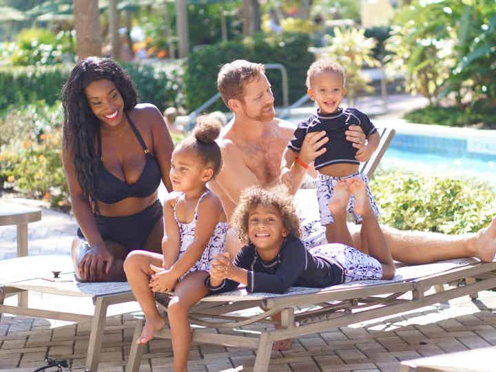 Family of five sitting by lazy river at Orange Lake Resort near Orlando, Florida.