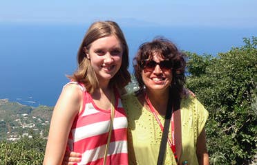 Featured Author, Jennifer Probst (right) stands with her niece (left) in front of a hill that overlooks the coastline of Italy.