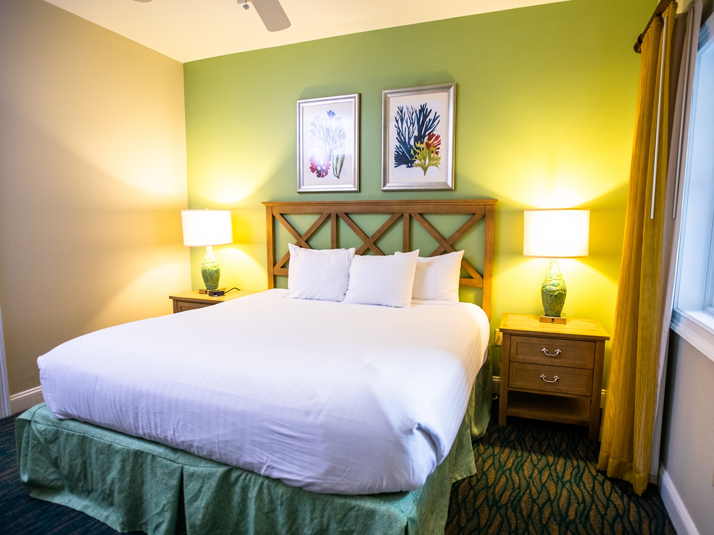 Bedroom with bed and window in a two-bedroom villa at South Beach Resort in Myrtle Beach, South Carolina.